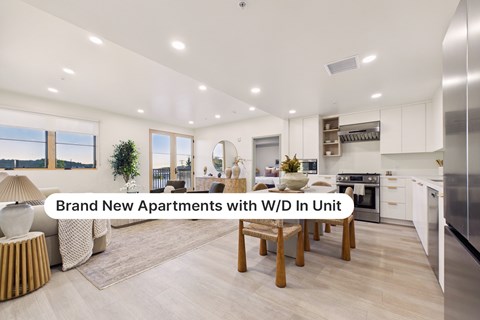 A modern kitchen with a dining table and chairs in a new apartment.