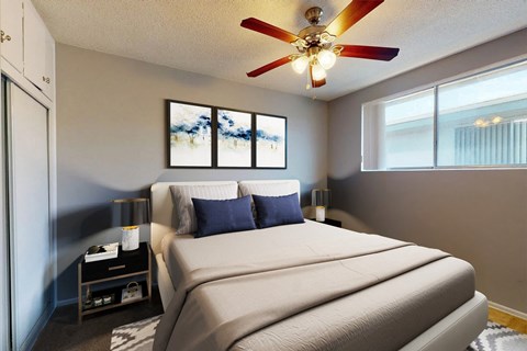A bedroom with a large bed and a ceiling fan.