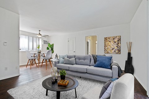 A living room with a grey couch and a coffee table.