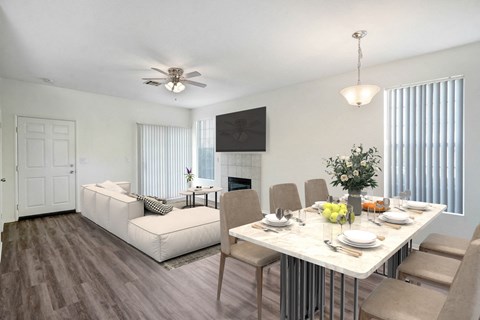 A dining room with a white table and chairs.