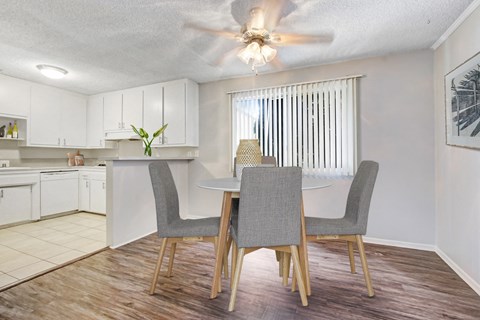 A dining room with a table and chairs.