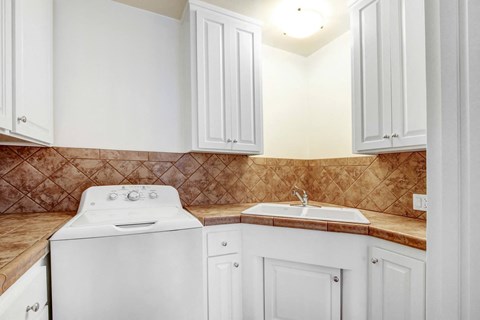 a white kitchen with white appliances and white cabinets