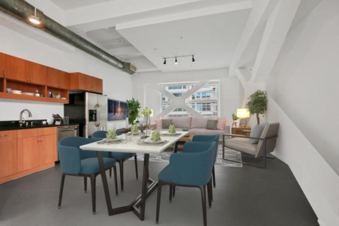 A modern kitchen with a dining table and chairs.