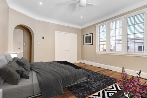 a bedroom with a bed and a ceiling fan