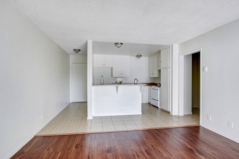 A kitchen with white cabinets and a white island.