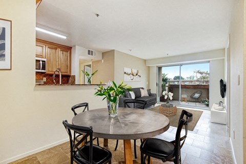 A dining room with a table and chairs.
