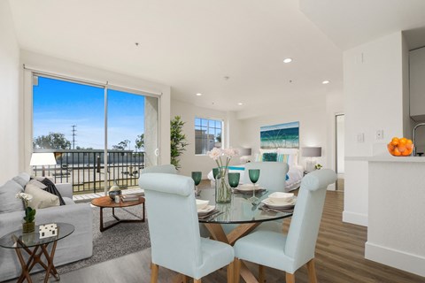 A dining room with a glass table and chairs.
