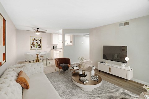 A living room with a white couch and a television.