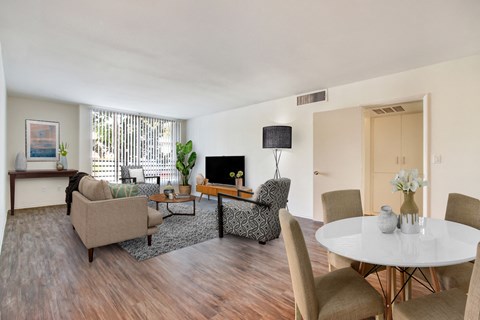 A living room with a white table and chairs.
