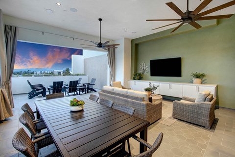 a large living room with a wooden table and chairs