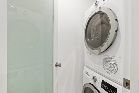 A white front loading washing machine with a transparent door.