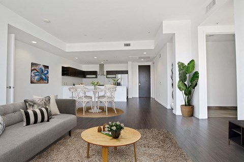 A living room with a grey couch and a wooden coffee table.