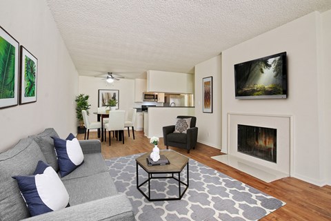 A living room with a grey couch and a coffee table.