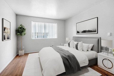 a bedroom with a large bed and a window