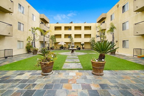 a courtyard with a fountain in the middle of an apartment building