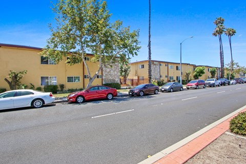 A red car is parked on the side of the street.