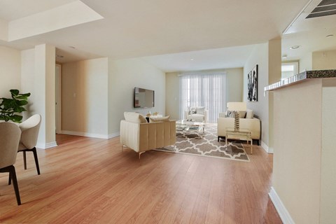 a living room and dining room with a hard wood floor