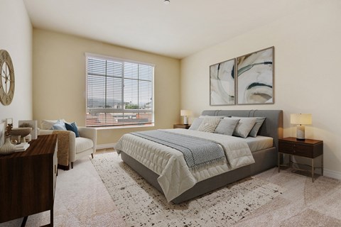 A bedroom with a large bed and a painting on the wall.