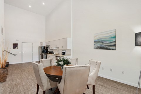A dining room with a table set for two.