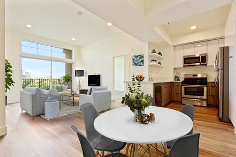 A modern kitchen with a dining table and chairs.