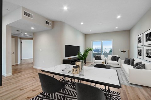 a living room with white walls and hardwood floors
