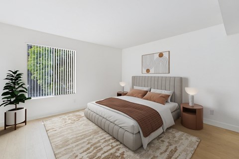 A bedroom with a large bed and a potted plant.