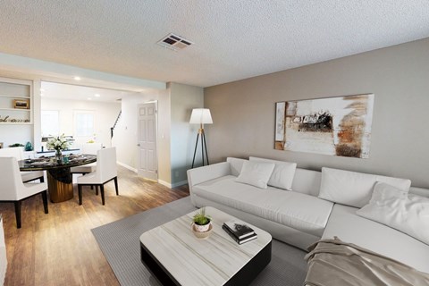 A modern living room with a white couch and a coffee table.
