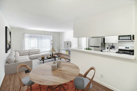 a living room with a table and a couch and a kitchen