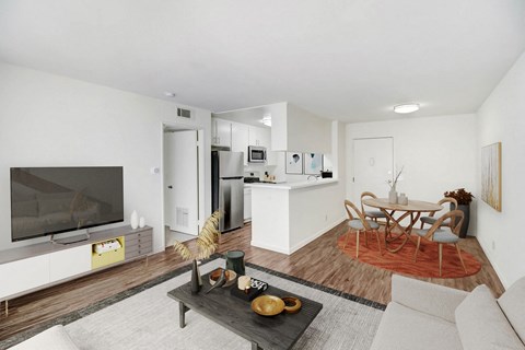 A modern living room with a white couch and a wooden coffee table.