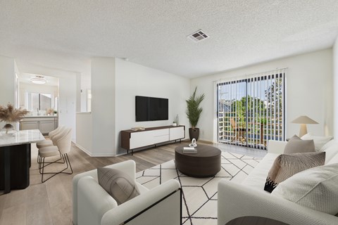 A living room with a white couch and a television.