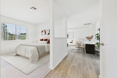 A bedroom with a bed and a chair in it.