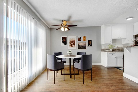A dining room with a table and chairs.