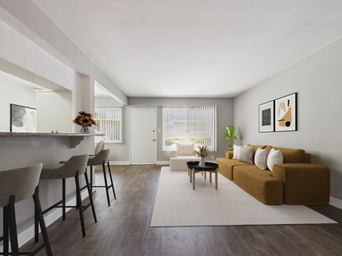 A living room with a brown couch and a white chair.
