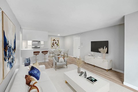 A modern living room with a white sofa and a coffee table.