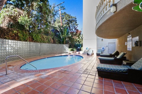 A small pool with a metal fence around it.