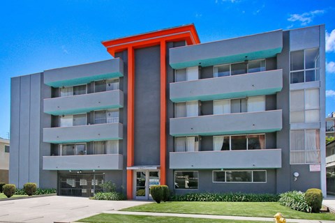 an apartment building with an orange and gray facade