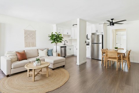 A living room with a white couch and a wooden coffee table.