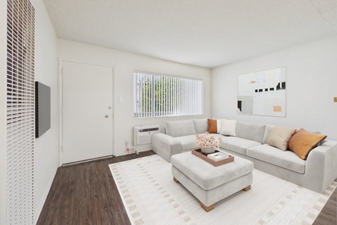 A living room with a white couch and a coffee table.