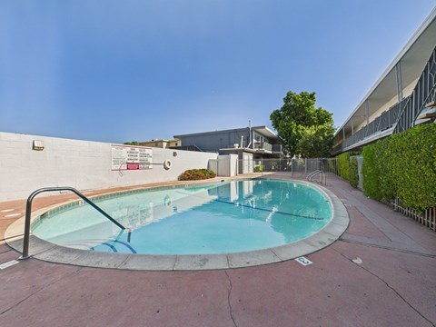 A round pool with a metal railing around it.
