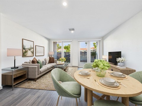 A modern dining room with a round table set for two.