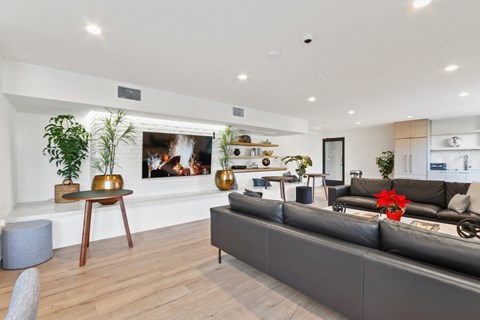 A modern living room with a grey sofa and a wooden table.