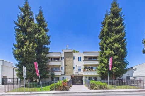 A modern building with a flag on the left and right side.