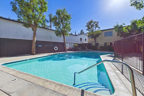 A small pool with a metal railing and steps leading into it.
