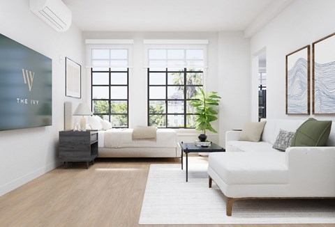 A living room with a white couch and a black coffee table.