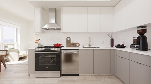 A modern kitchen with a black oven and a red pot on top.