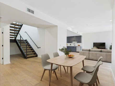 A dining room with a round table and chairs.