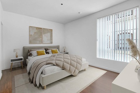 a bedroom with a bed and a large window