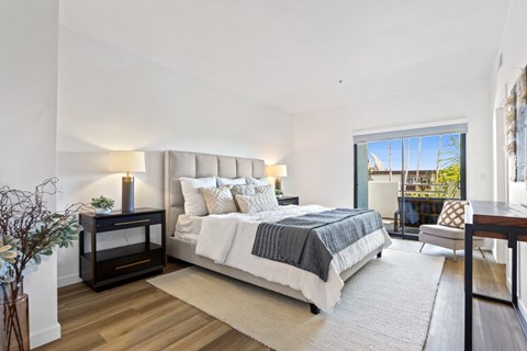 A bedroom with a large bed and a fireplace.