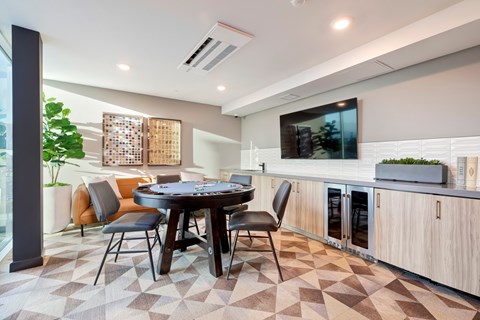 A modern dining room with a round table and chairs.