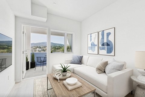 A living room with a white couch and a coffee table.